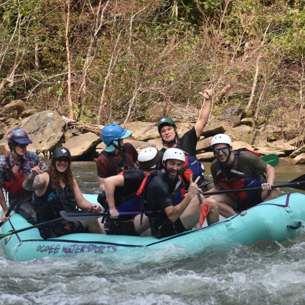 Theo Von with a group of people on a raft on the Ocoee River.