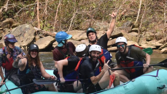 Theo Von with a group of people on a raft on the Ocoee River.