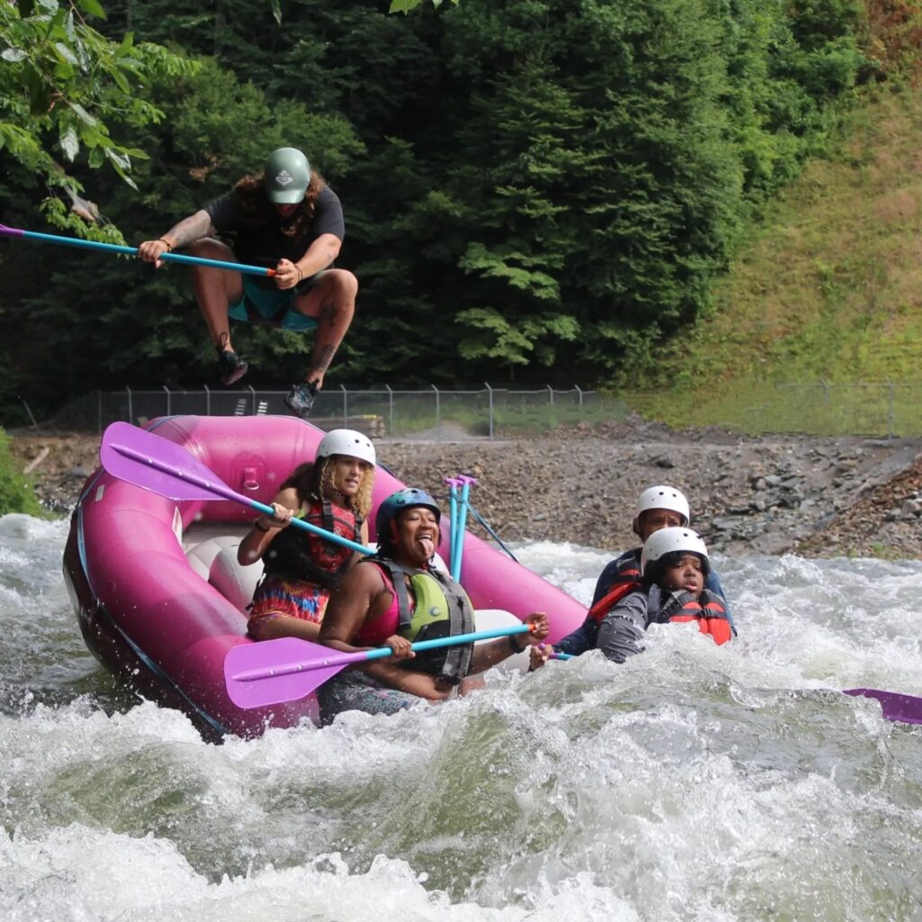 A guide in the back of the raft while heading into Hell's Hole on the Ocoee River.