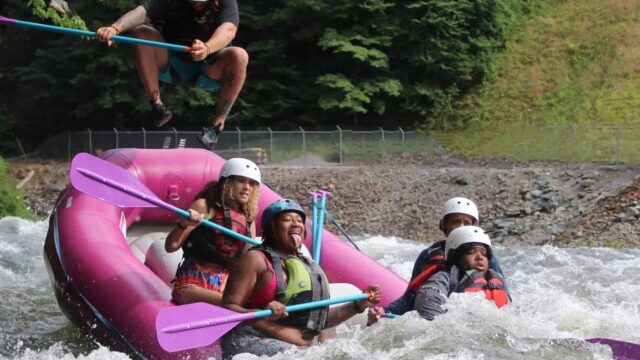A guide in the back of the raft while heading into Hell's Hole on the Ocoee River.