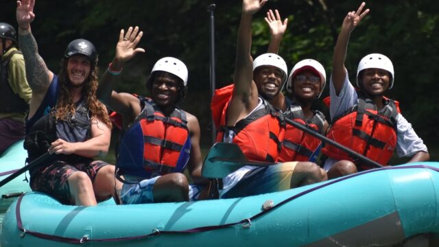 Rafters waving to the camera on the Ocoee River.