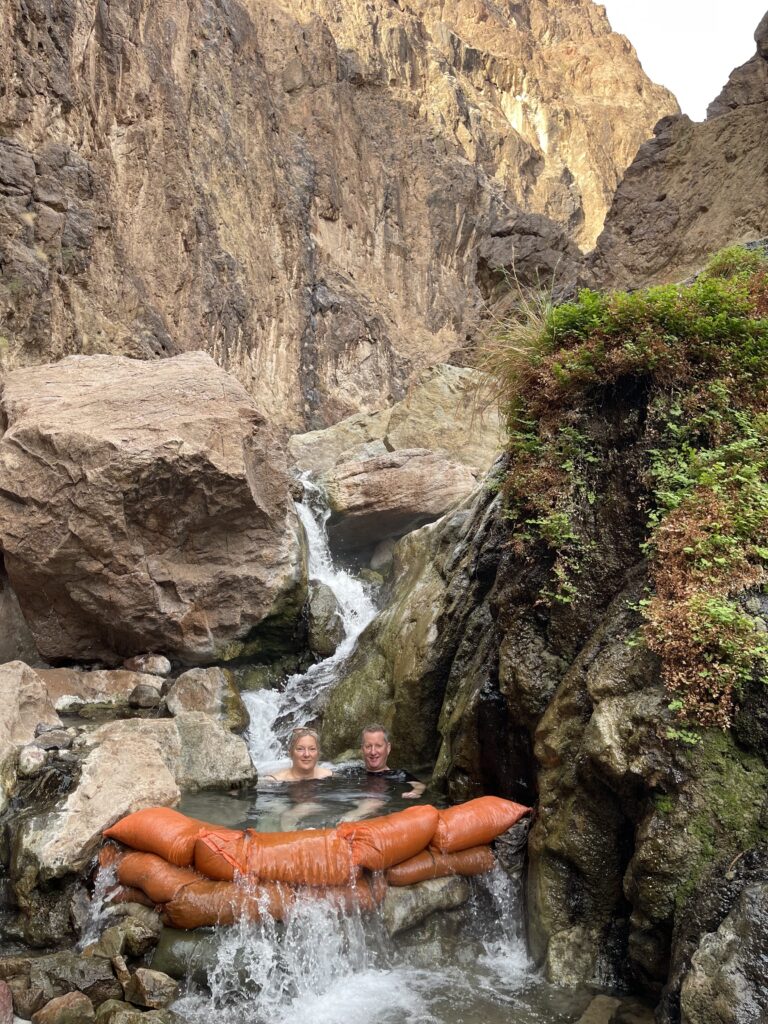 Blazing paddles couple enjoys the hot spring on their trip.