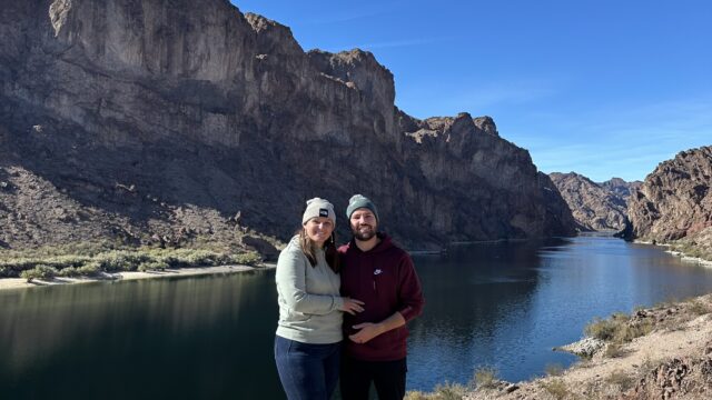 Blazing paddles takes a photo of a happy couple on their trip down the river.