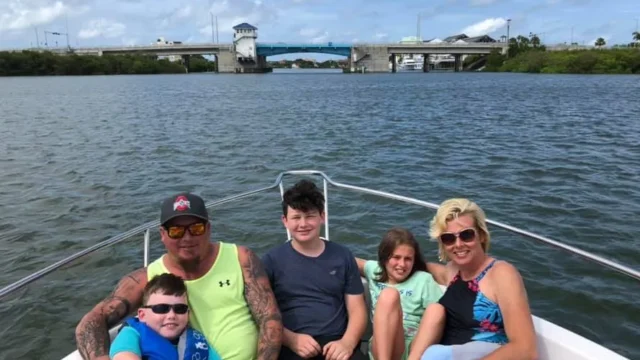 A family poses on the bow of a boat in Madeira Beach, Florida.