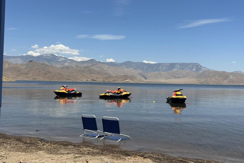 Three jet skis and two beach chairs on Lake Isabella.