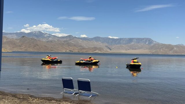 Three jet skis and two beach chairs on Lake Isabella.