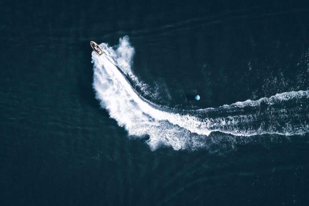 An aerial view of a jet ski speeding on water.
