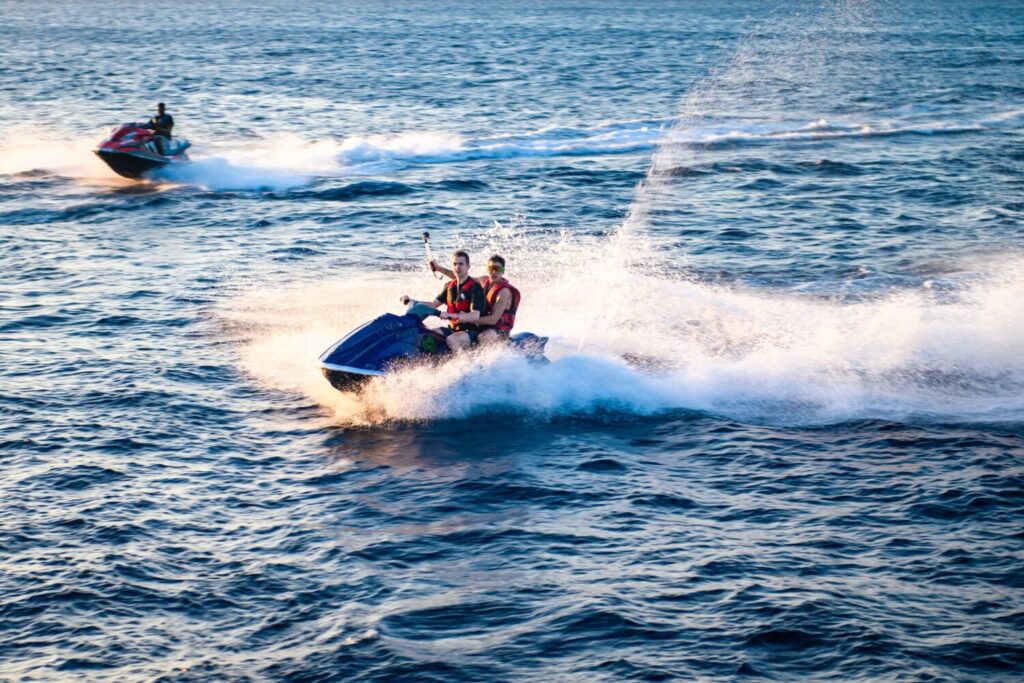 Two people tandem on a jet ski.