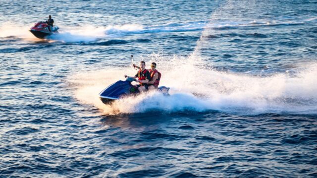 Two people tandem on a jet ski.