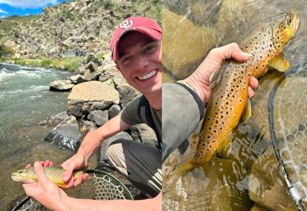 A man holding a trout on a river bank.