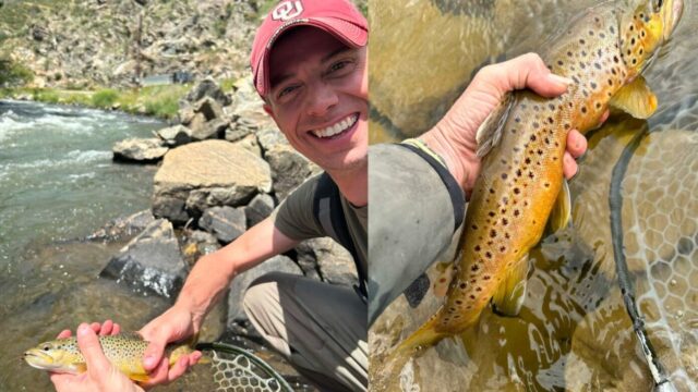 A man holding a trout on a river bank.