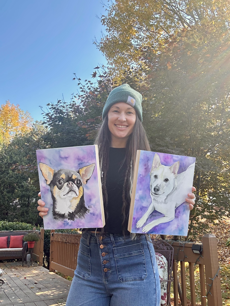 Girl holding two pet portraits