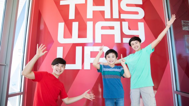 Kids in front of an iFLY sign.