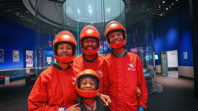 Family in iFly gear happy and ready to go flying.