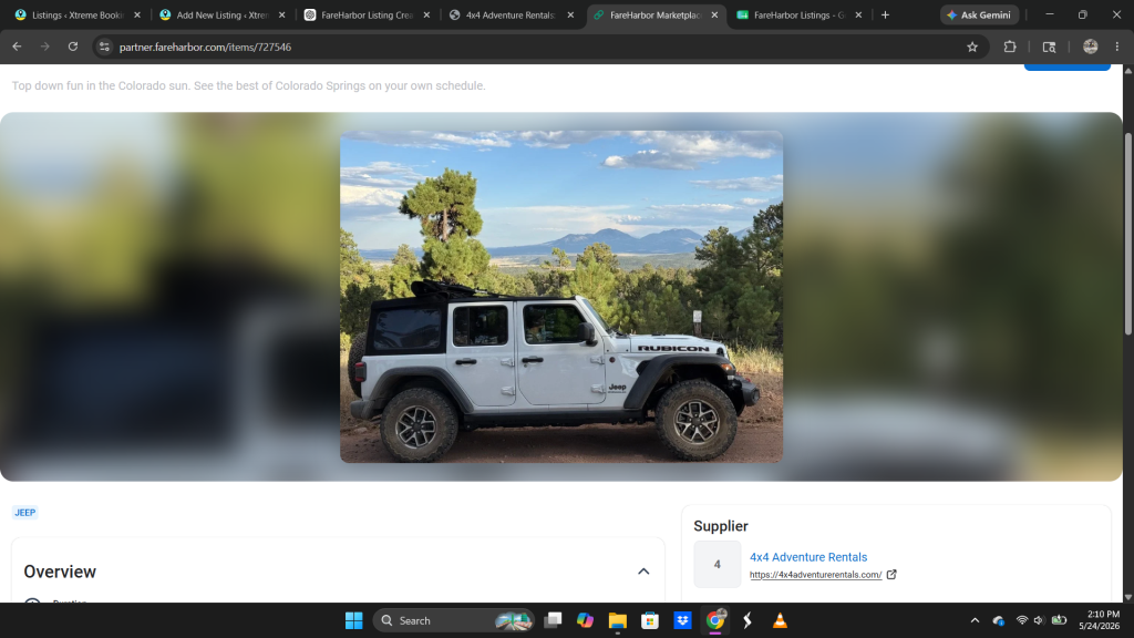 A white jeep with parked in the mountains.