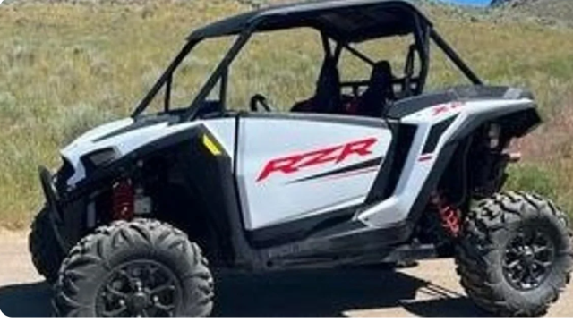 A white UTV vehicle outdoors.