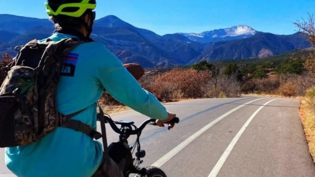 A cyclist riding on a mountain road.