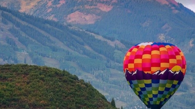 A hot air balloon in the mountains.