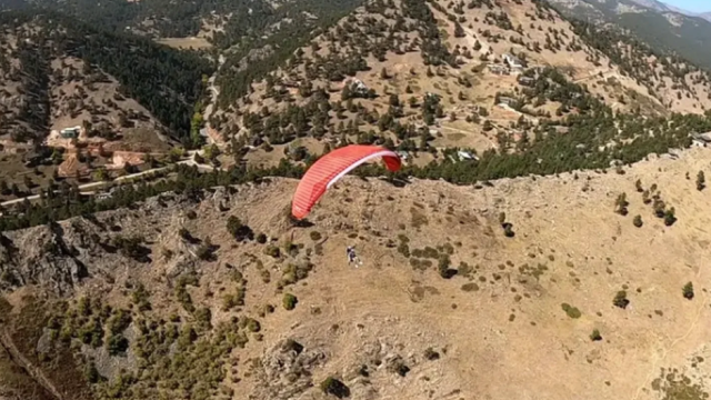 A paraglider in the mountains.