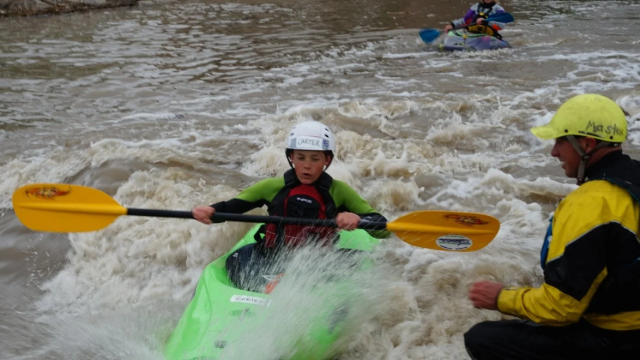 A kid kayaking.