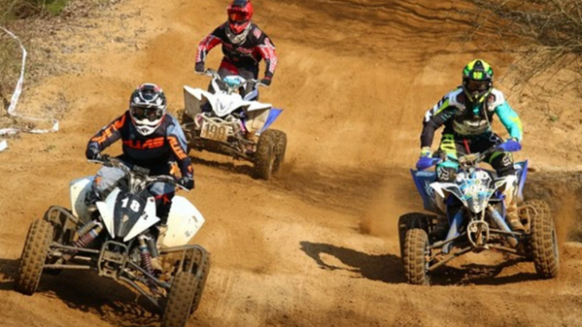 Three ATVs on a trail.