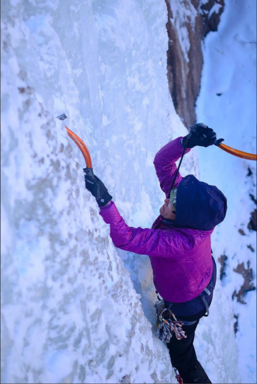 A woman ice climbing in colorado.