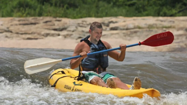 A kayaker on broad river.