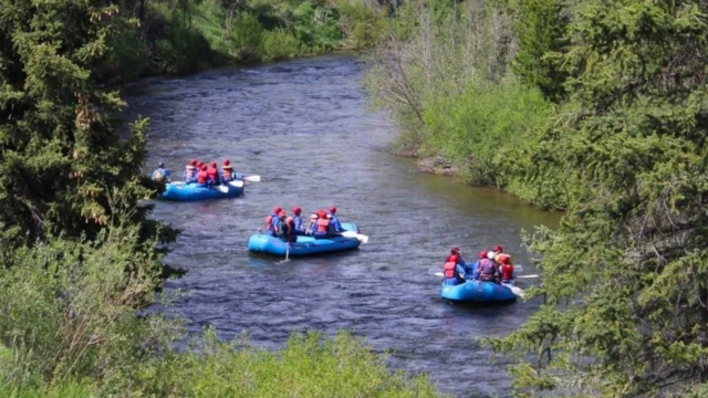 Three rafts on the blue river in colorado.
