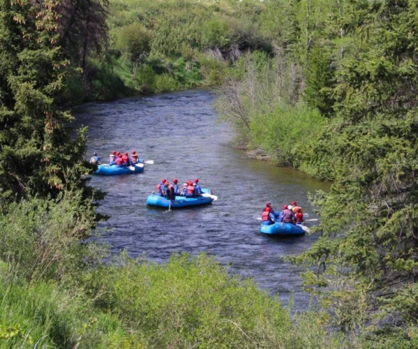 Three rafts on the blue river in colorado.